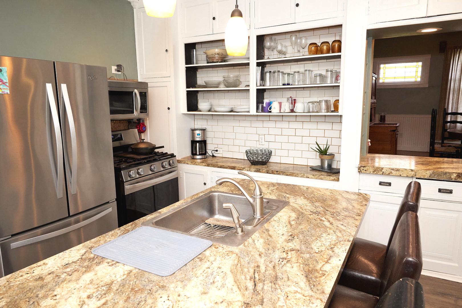 1406 Bluff Street Peru, IL 61354 - Photo 28 of 57 a kitchen with stainless steel appliances kitchen island granite countertop a refrigerator and a stove top oven