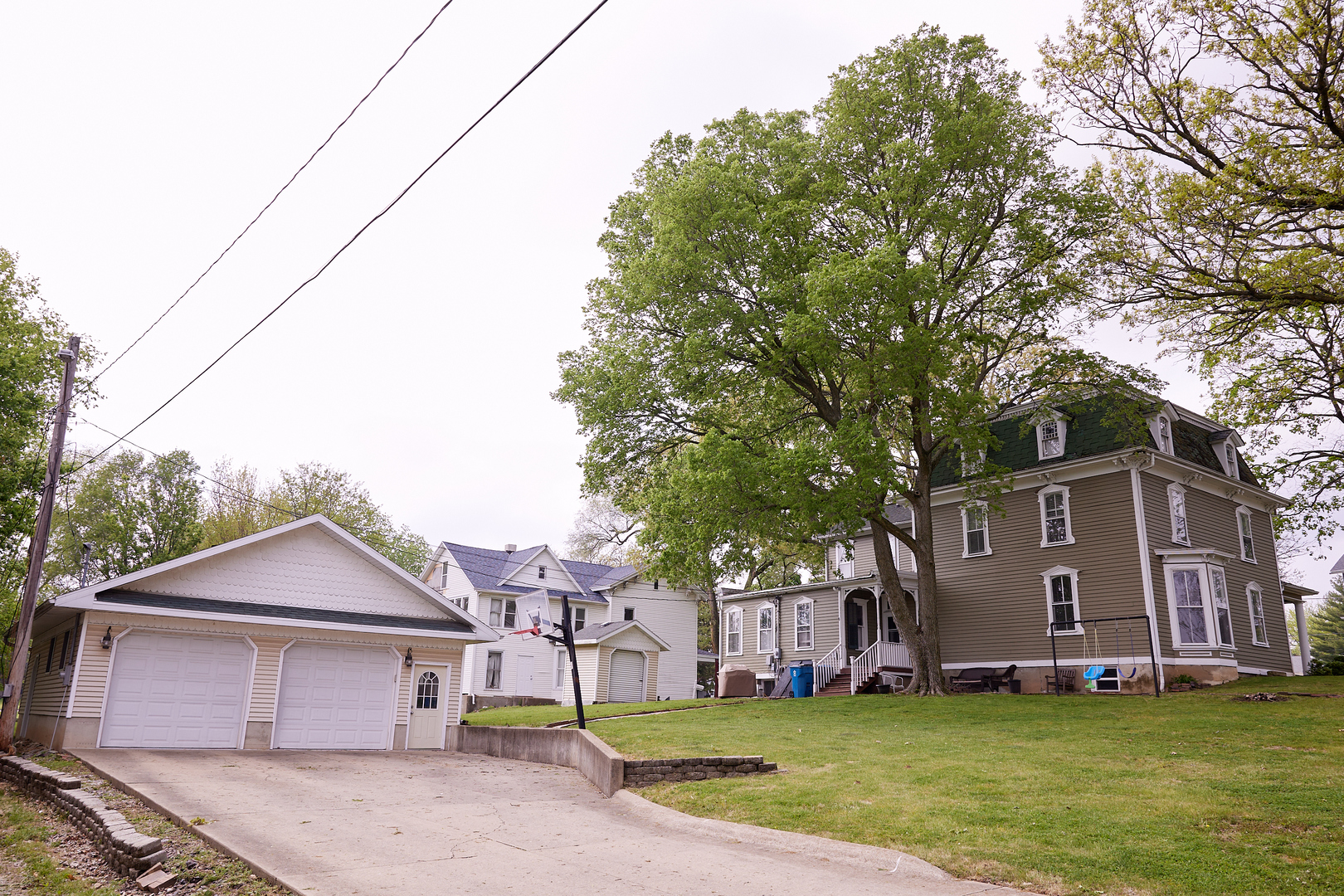 1406 Bluff Street Peru, IL 61354 - Photo 7 of 57 a front view of a house with a yard and garage