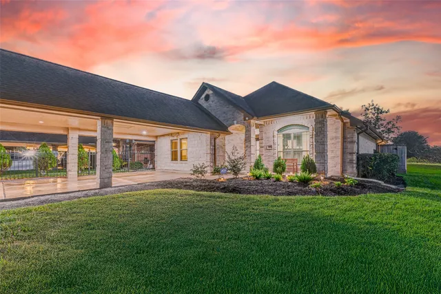 a front view of a house with a garden and plants