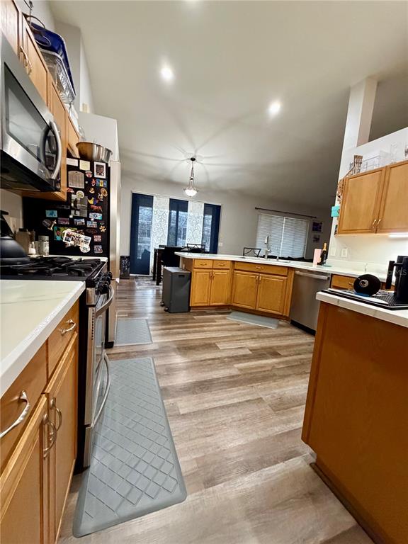 4303 Orange Ridge Court Valrico, FL 33596 - Photo 15 of 40 a large kitchen with stainless steel appliances granite countertop a stove and a refrigerator