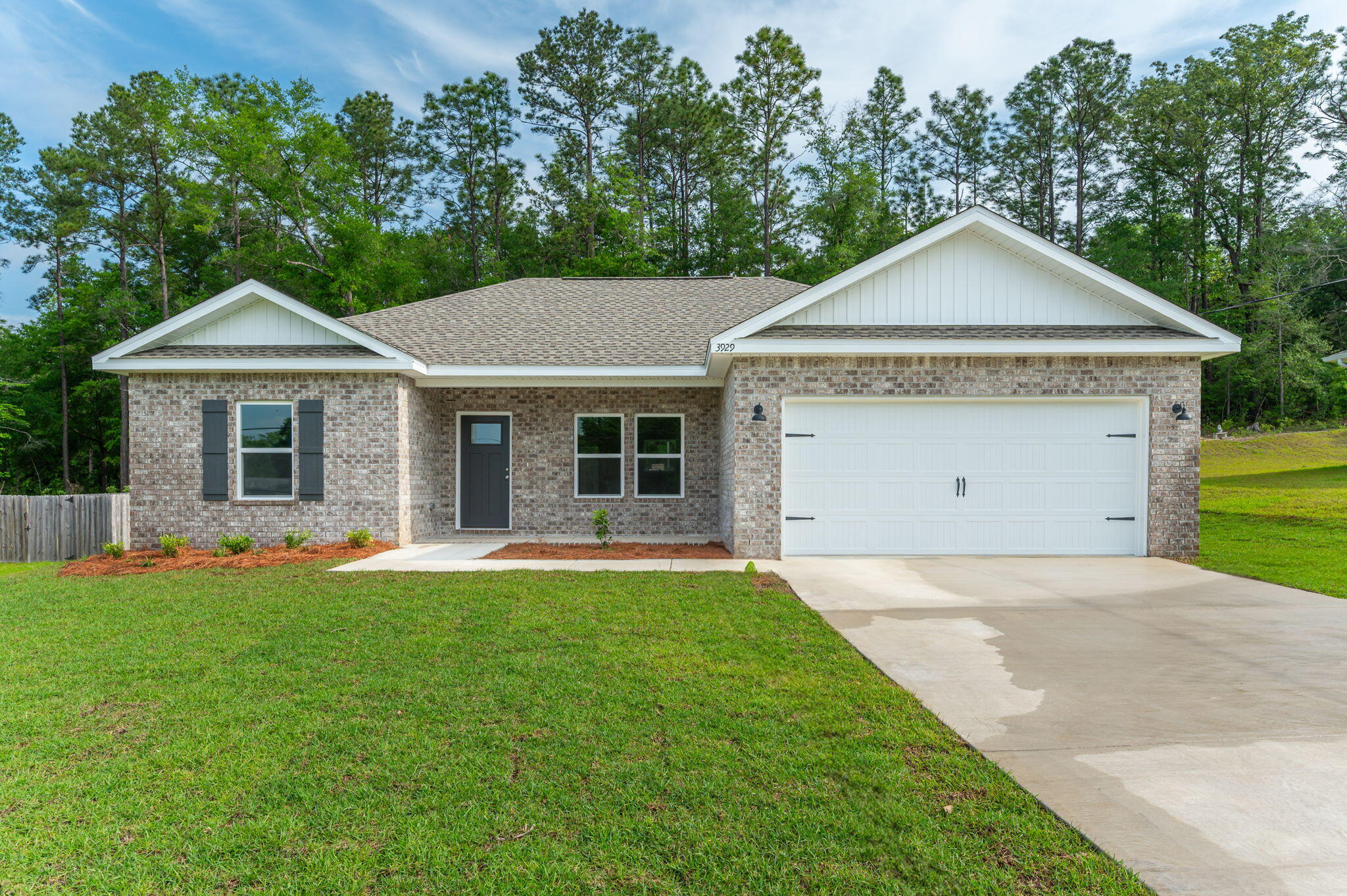 3929 Poverty Creek Road Crestview, FL 32539 - Photo 1 of 37 a front view of a house with a garden and yard