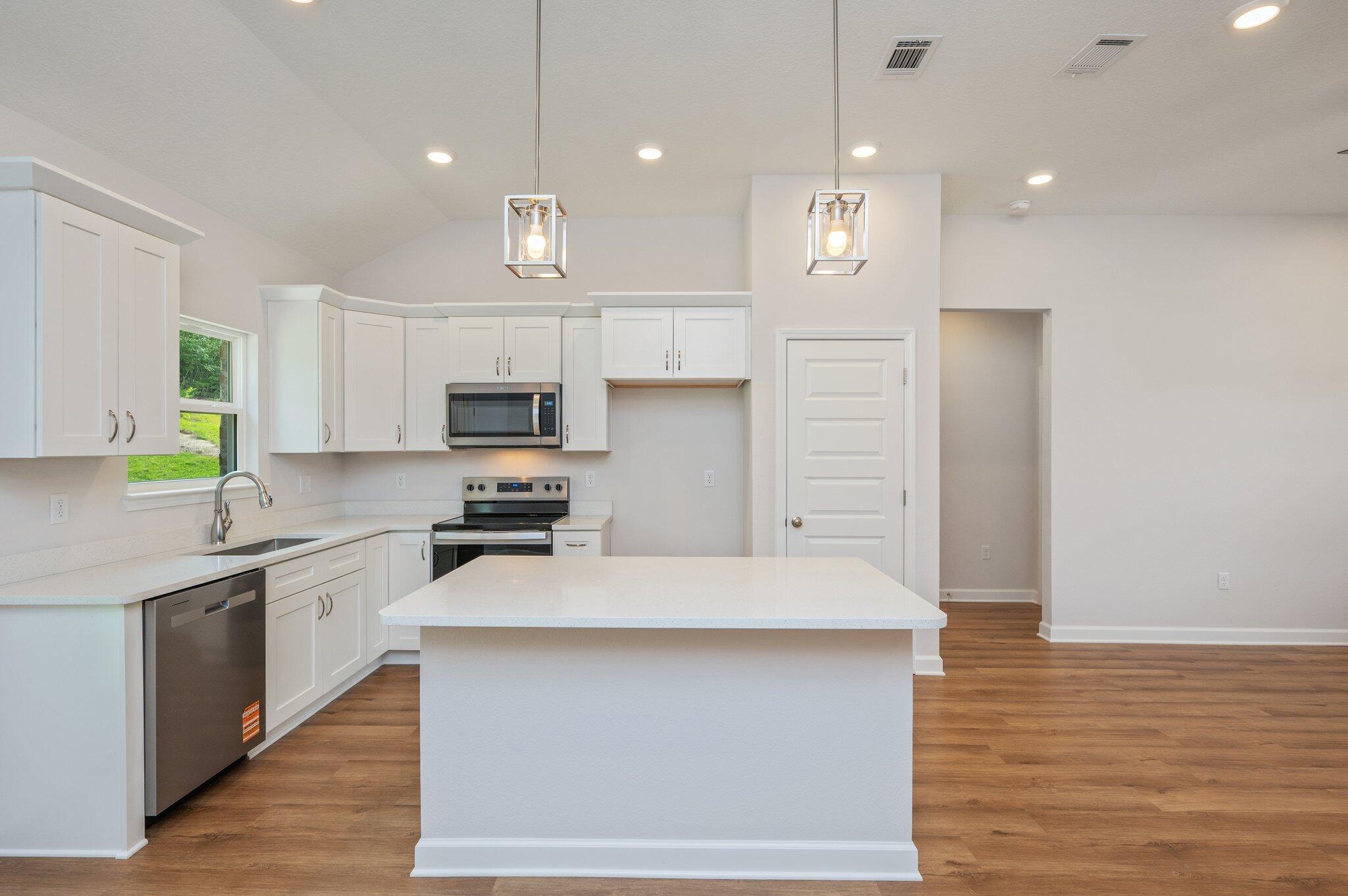 3929 Poverty Creek Road Crestview, FL 32539 - Photo 12 of 37 a large kitchen with cabinets