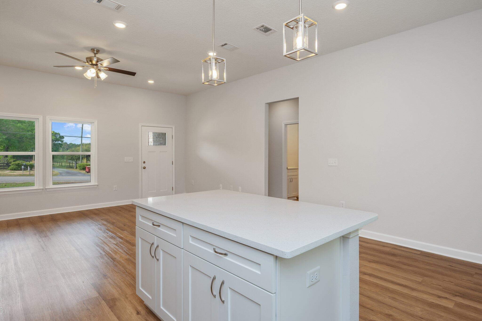 3929 Poverty Creek Road Crestview, FL 32539 - Photo 16 of 37 a kitchen with a table chairs and wooden floor