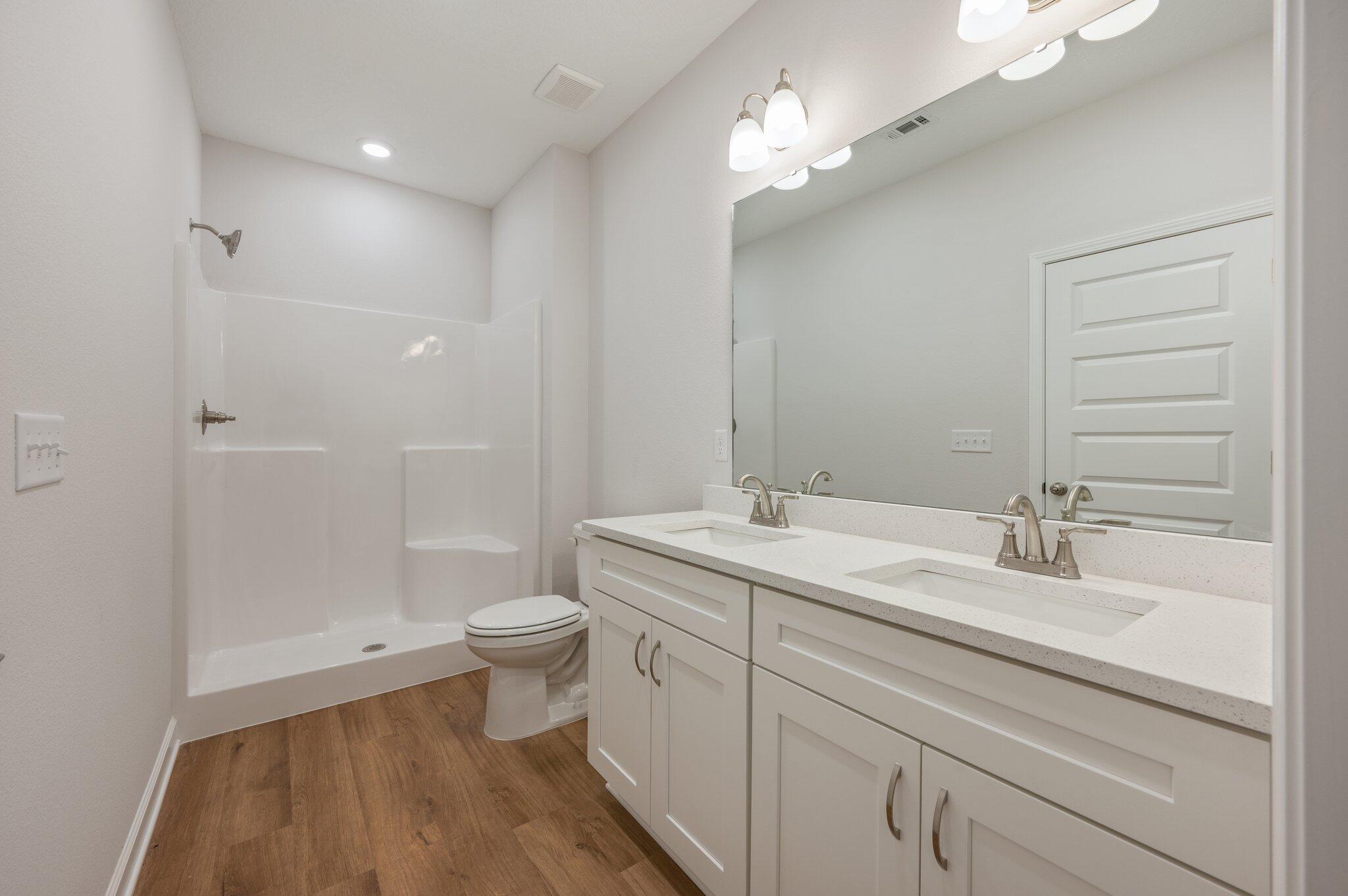 3929 Poverty Creek Road Crestview, FL 32539 - Photo 23 of 37 a bathroom with a double vanity sink toilet and shower