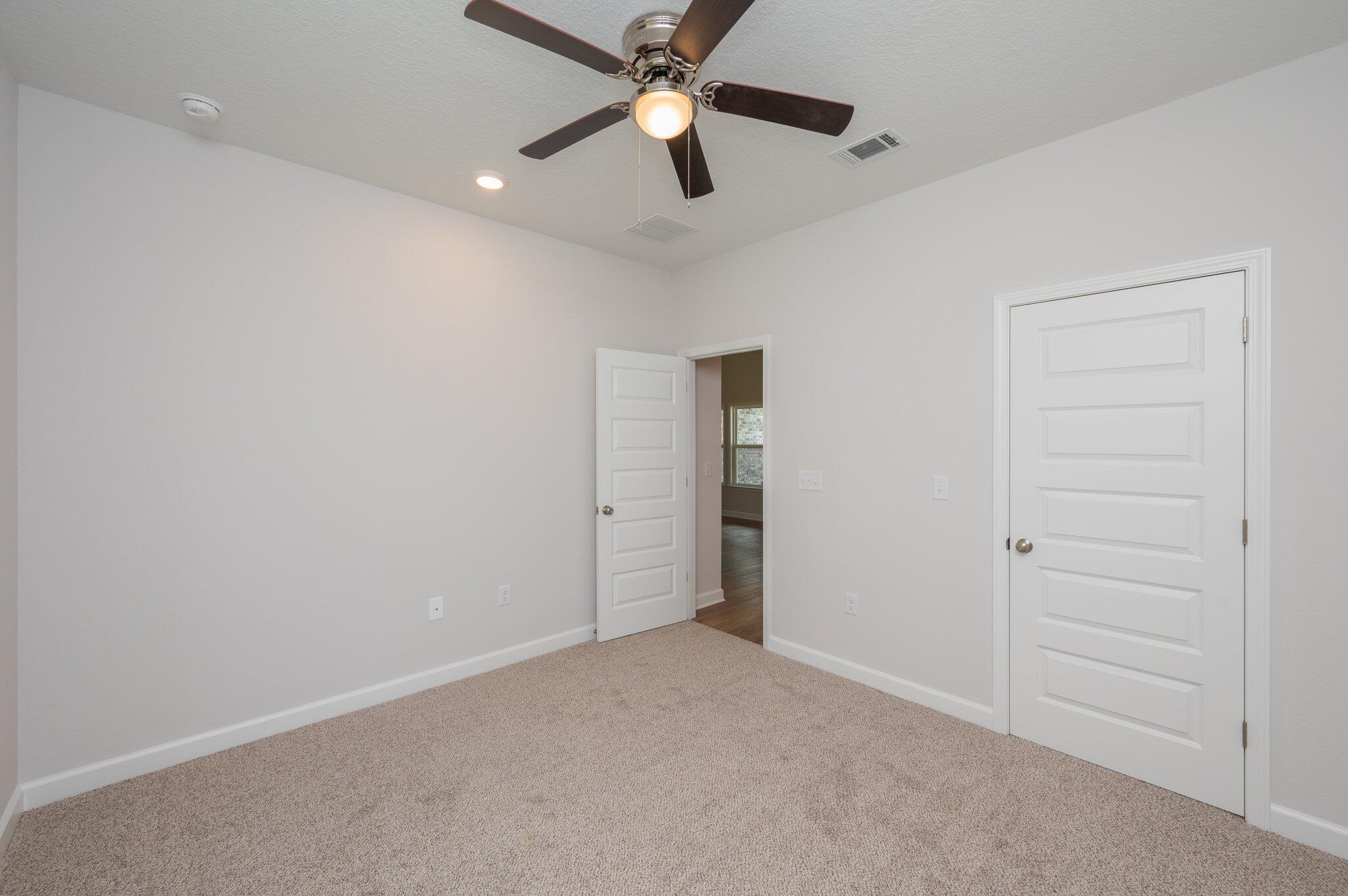 3929 Poverty Creek Road Crestview, FL 32539 - Photo 24 of 37 an empty room with closet and a chandelier fan