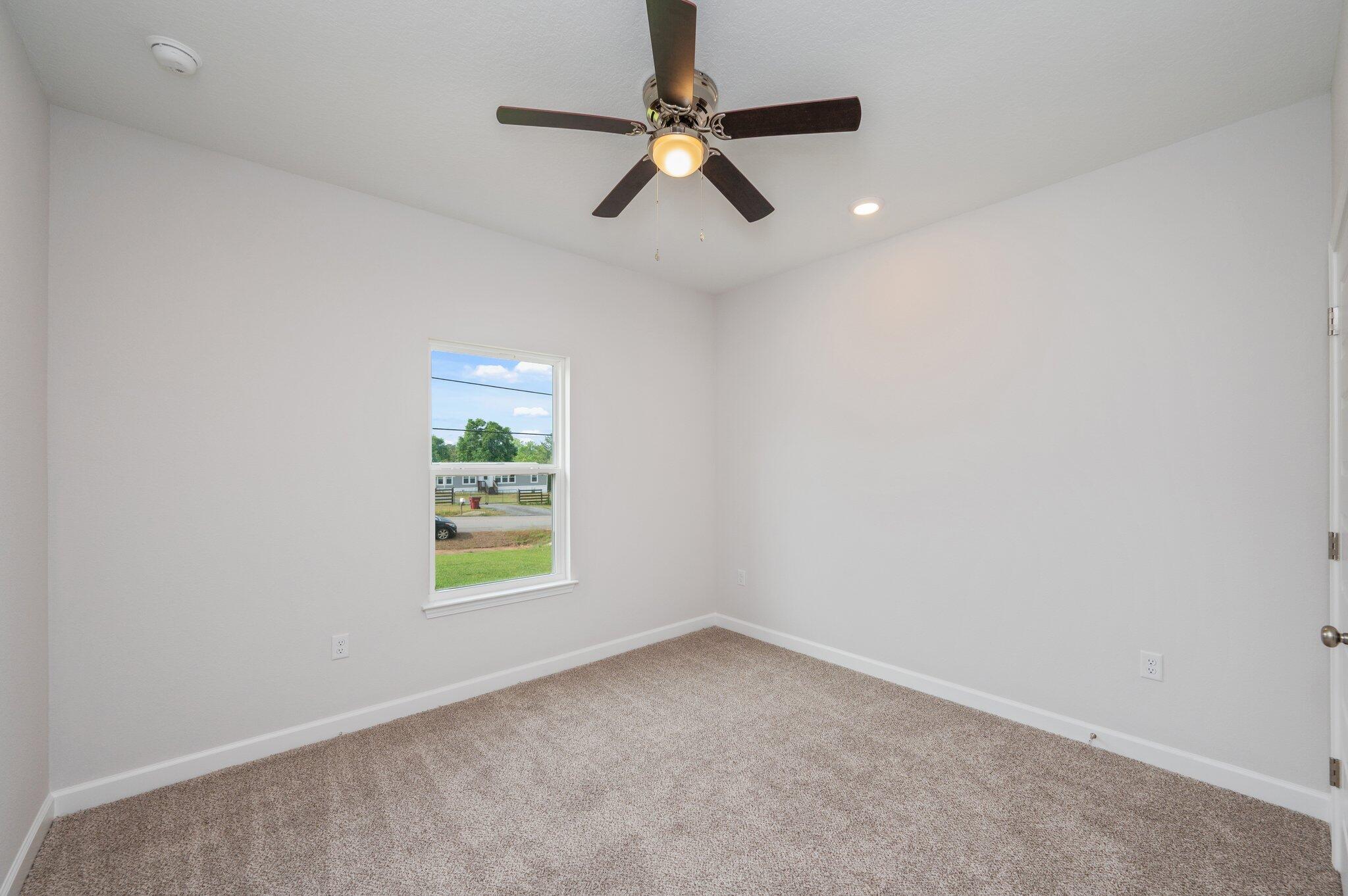 3929 Poverty Creek Road Crestview, FL 32539 - Photo 26 of 37 an empty room with windows and fan