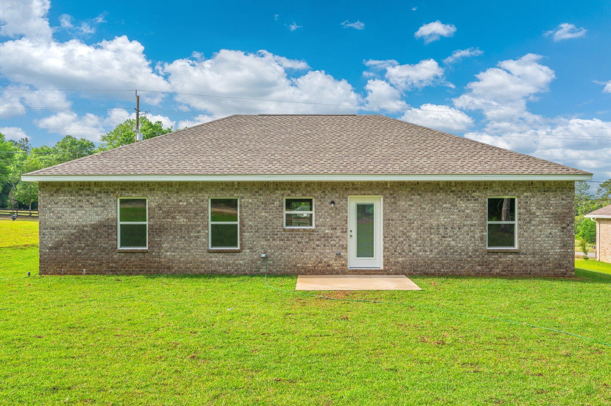 3929 Poverty Creek Road Crestview, FL 32539 - Photo 33 of 37 a front view of a house with garden