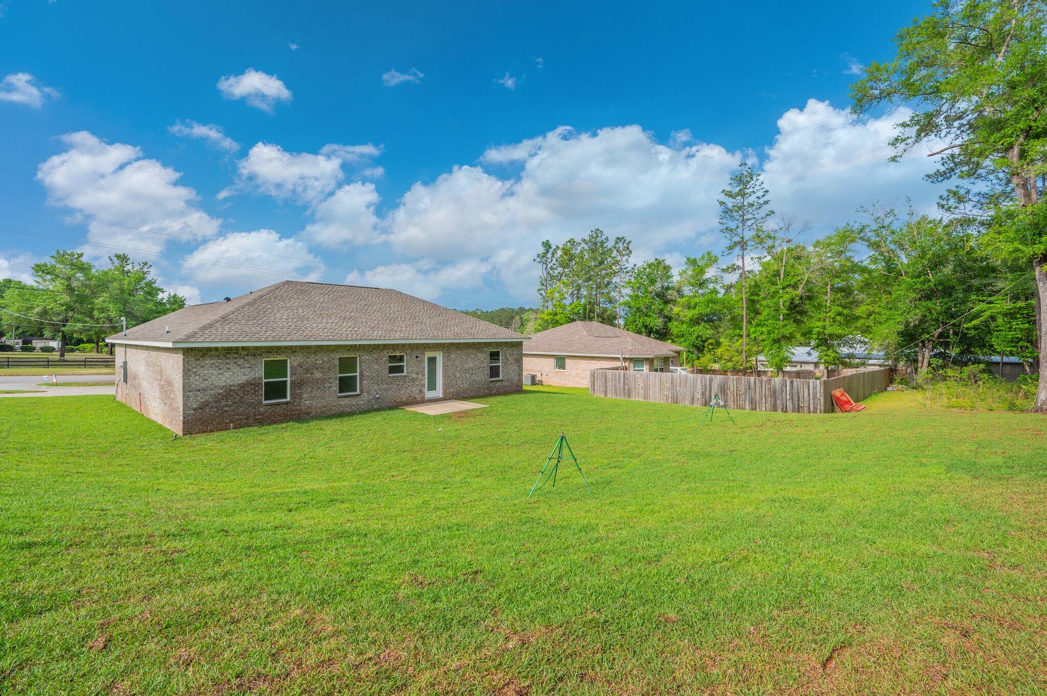 3929 Poverty Creek Road Crestview, FL 32539 - Photo 34 of 37 a view of a house with a yard and a garden