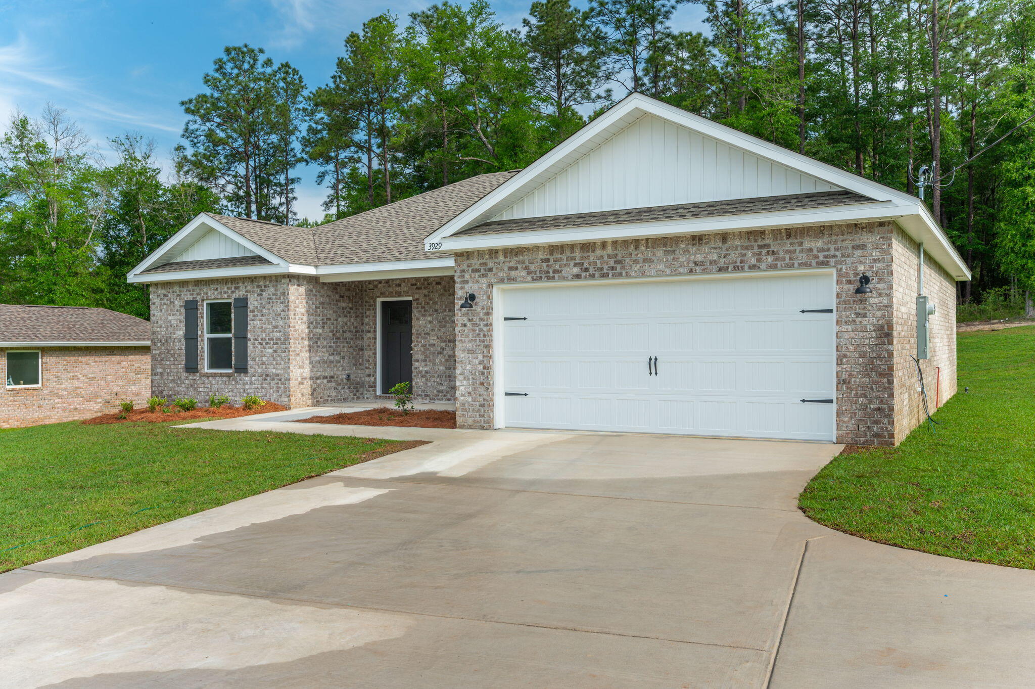 3929 Poverty Creek Road Crestview, FL 32539 - Photo 4 of 37 a front view of a house with a yard and garage