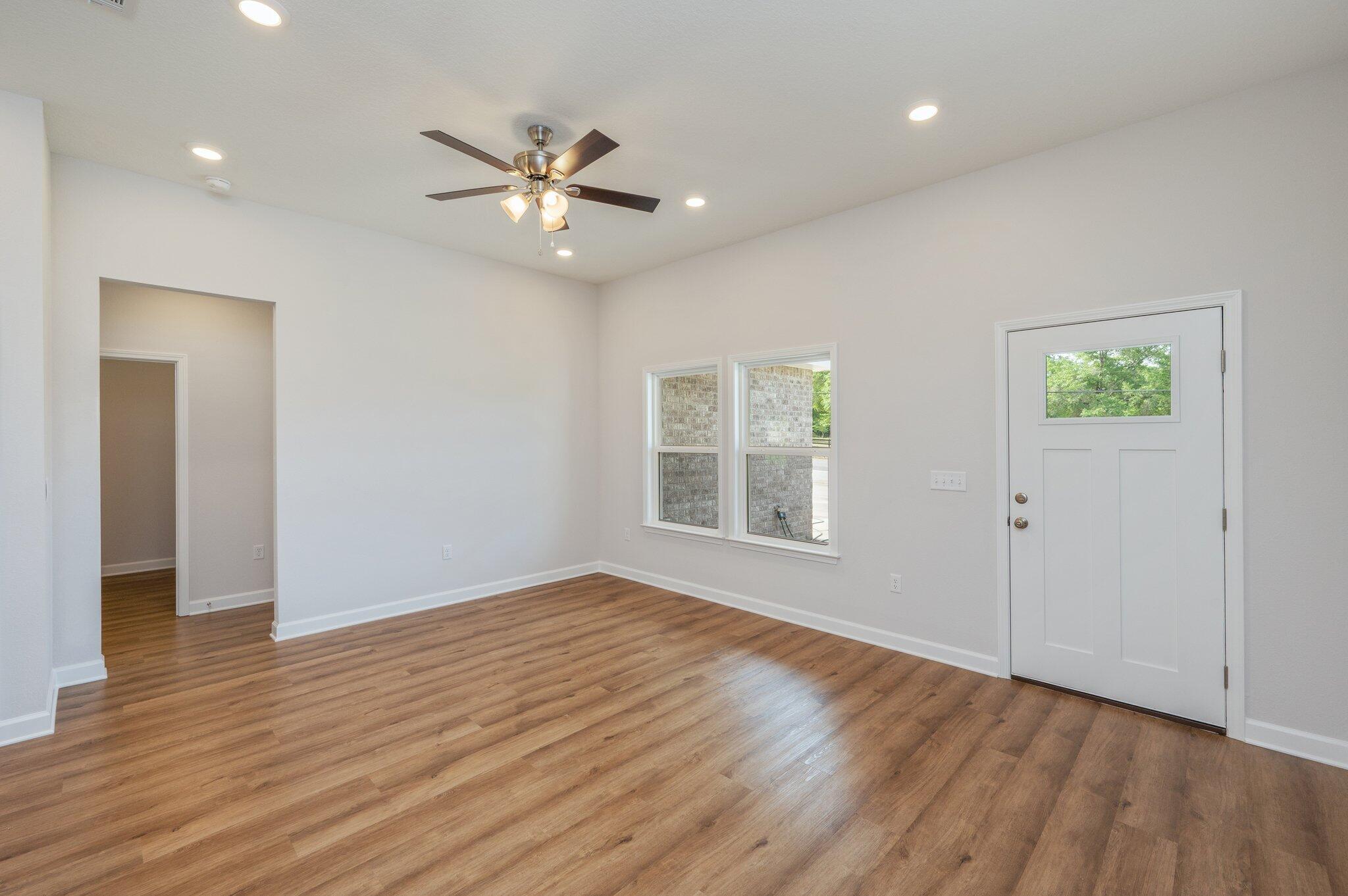 3929 Poverty Creek Road Crestview, FL 32539 - Photo 7 of 37 a view of an empty room with wooden floor and a window