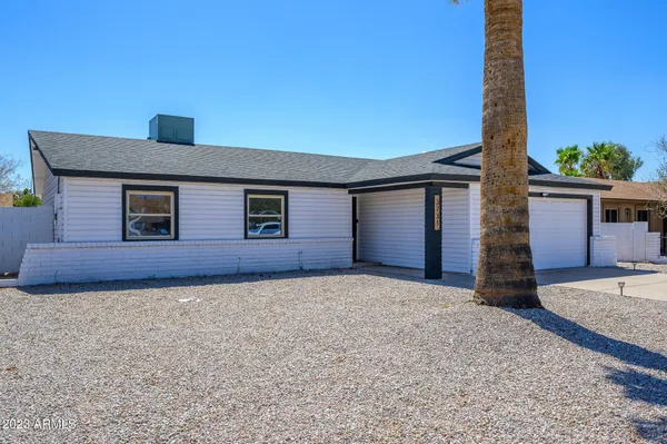 a view of a house with a backyard