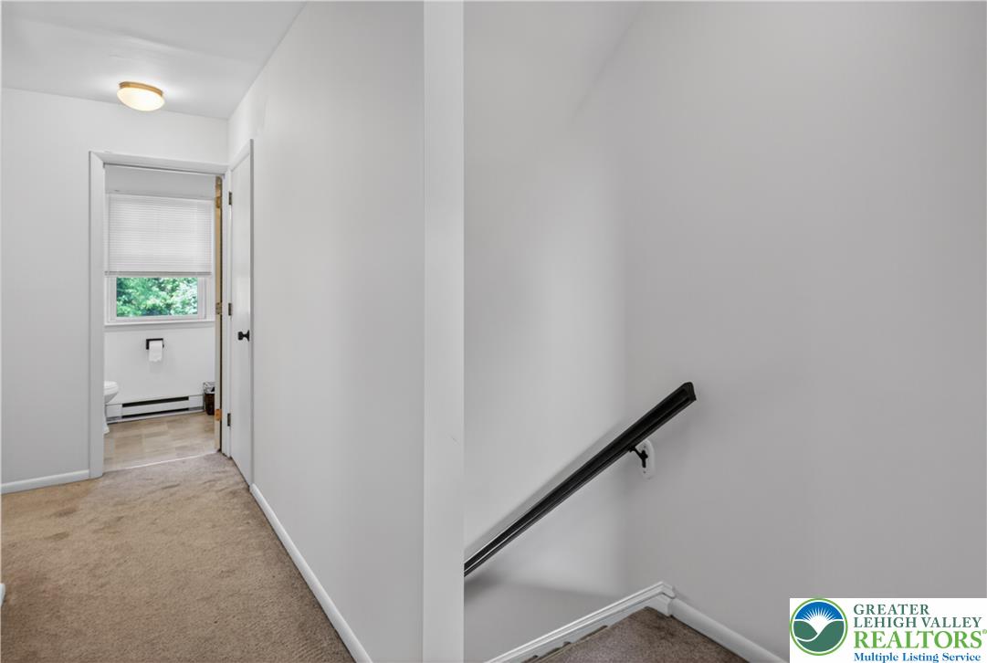 479 South 9th Street Akron, PA 17501 - Photo 17 of 33 A clean, well-maintained hallway with carpeting leads to a conveniently located bathroom and a descending staircase.
