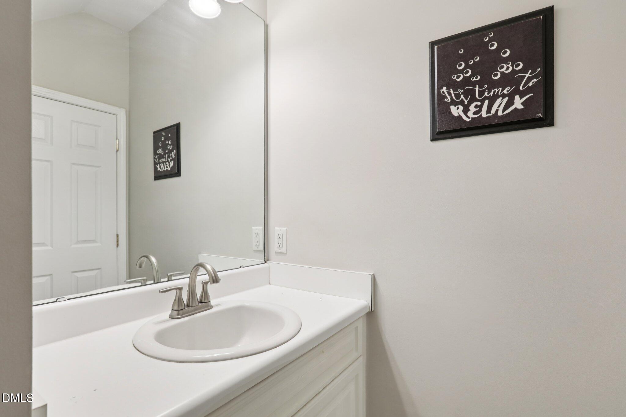 1212 Southgate Drive Raleigh, NC 27610 - Photo 13 of 31 a bathroom with a sink and a mirror