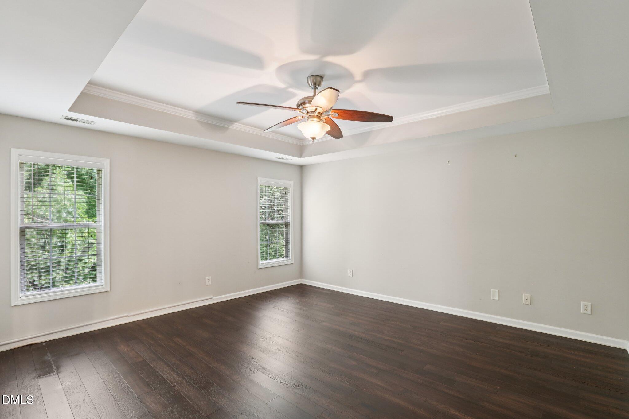 1212 Southgate Drive Raleigh, NC 27610 - Photo 14 of 31 a view of a room with wooden floor and a ceiling fan