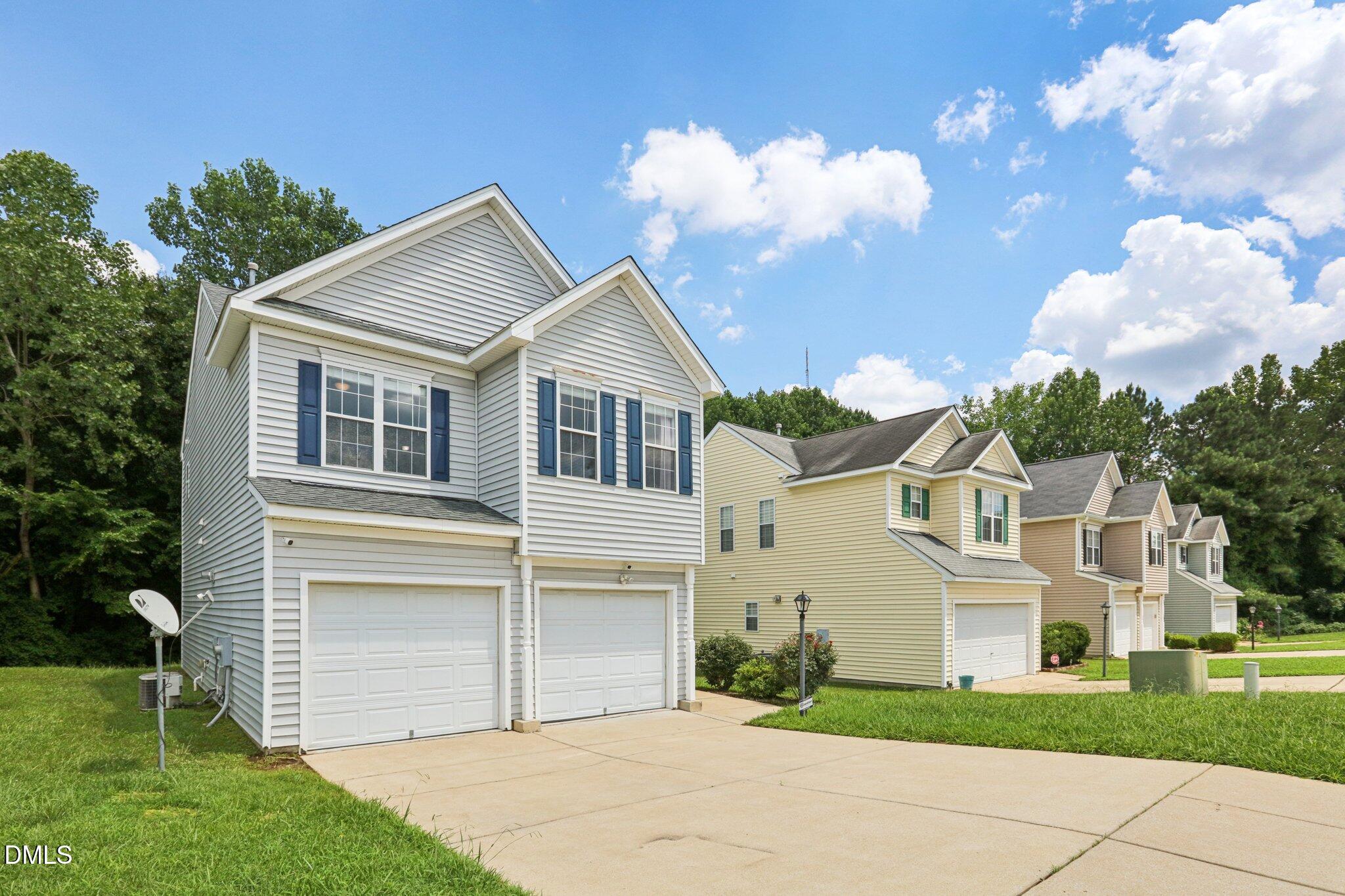 1212 Southgate Drive Raleigh, NC 27610 - Photo 2 of 31 a view of a white house next to a yard with big trees