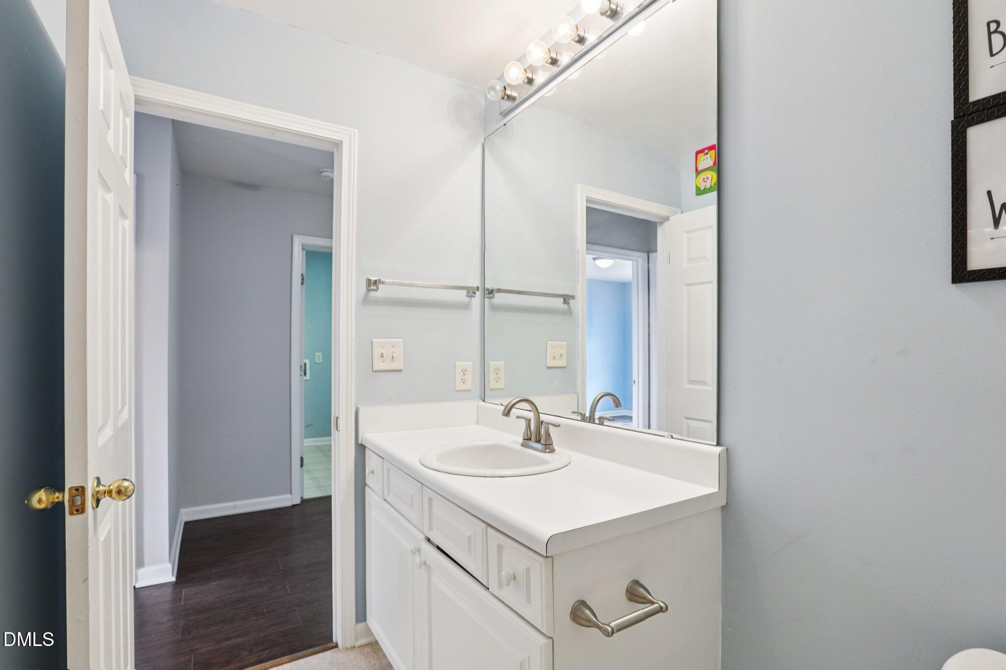 1212 Southgate Drive Raleigh, NC 27610 - Photo 22 of 31 a bathroom with a sink and a mirror