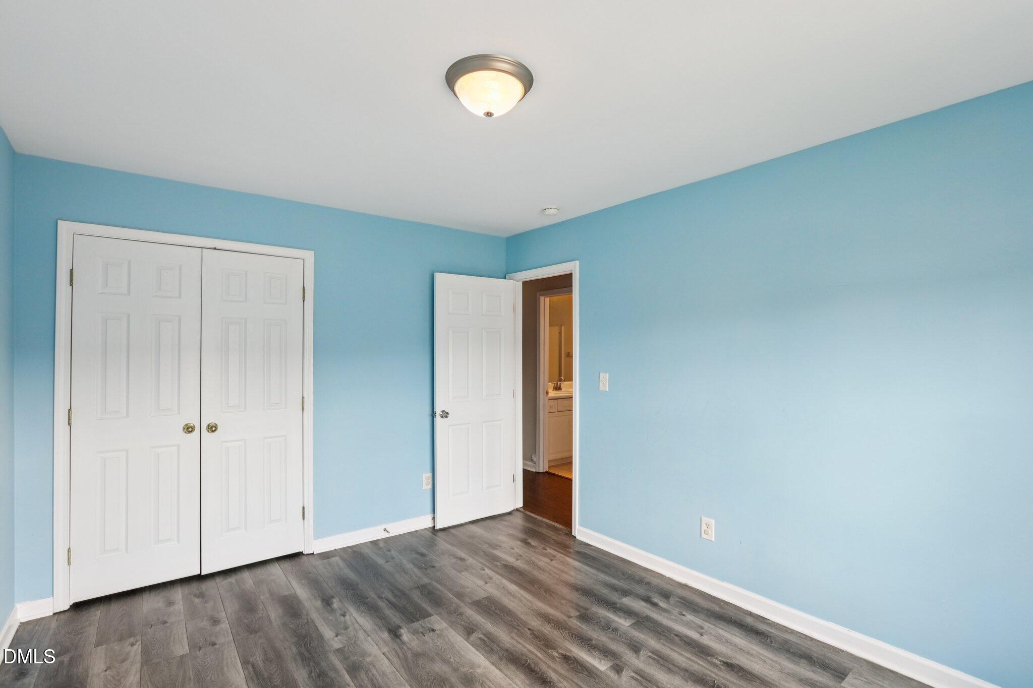 1212 Southgate Drive Raleigh, NC 27610 - Photo 25 of 31 a view of an empty room with wooden floor