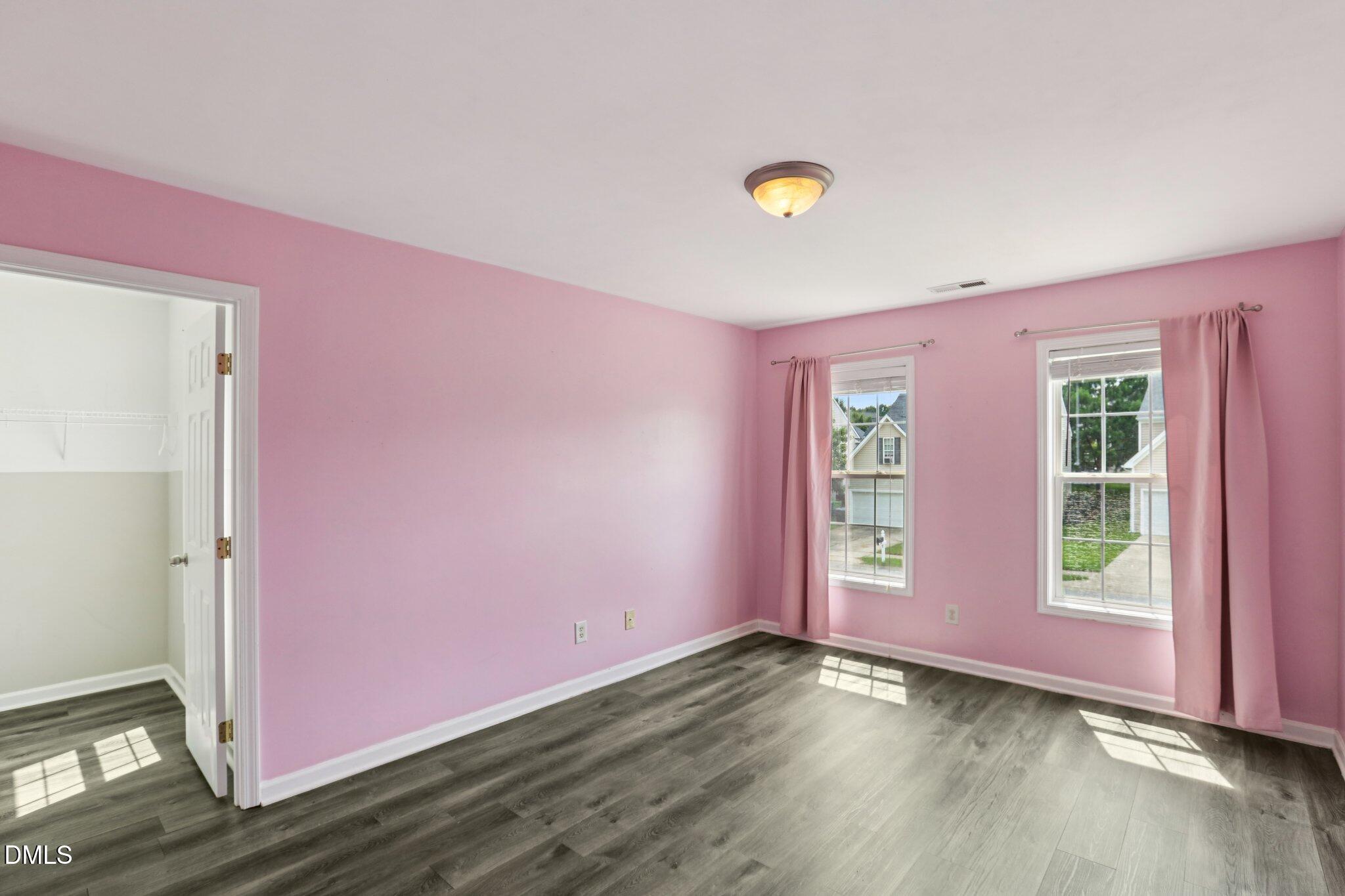 1212 Southgate Drive Raleigh, NC 27610 - Photo 26 of 31 an empty room with wooden floor and windows