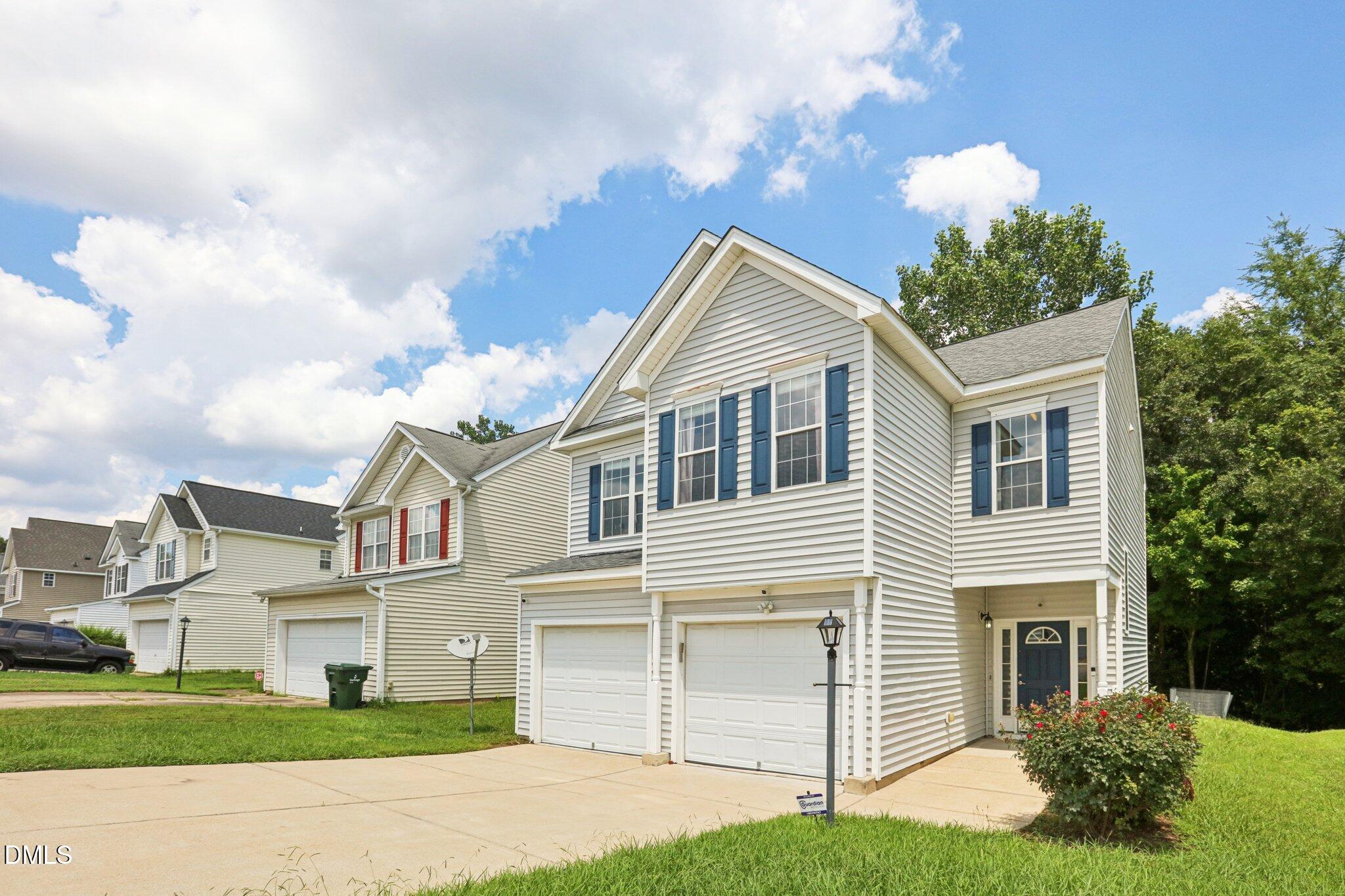 1212 Southgate Drive Raleigh, NC 27610 - Photo 3 of 31 a front view of a house with a garden and garage