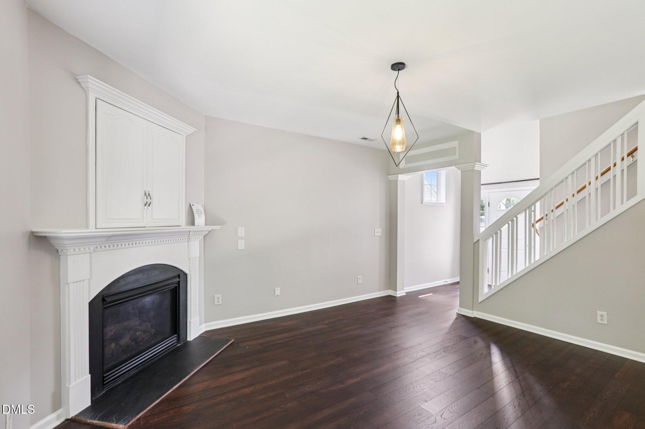 1212 Southgate Drive Raleigh, NC 27610 - Photo 7 of 31 a view of empty room with wooden floor and fireplace