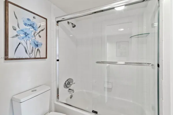 a bathroom with a shower and a toilet