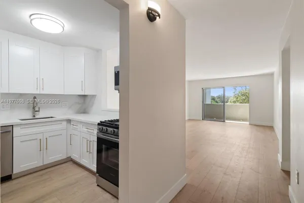 a kitchen with granite countertop a stove and a refrigerator