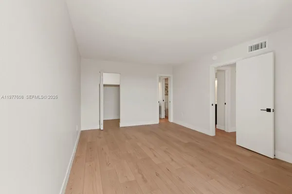 a view of an empty room and closet area