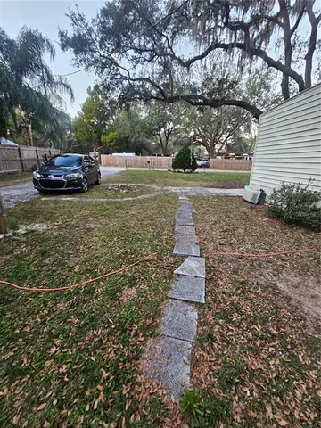a pathway of a house with a yard