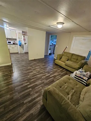 a living room with couch and a wooden floor