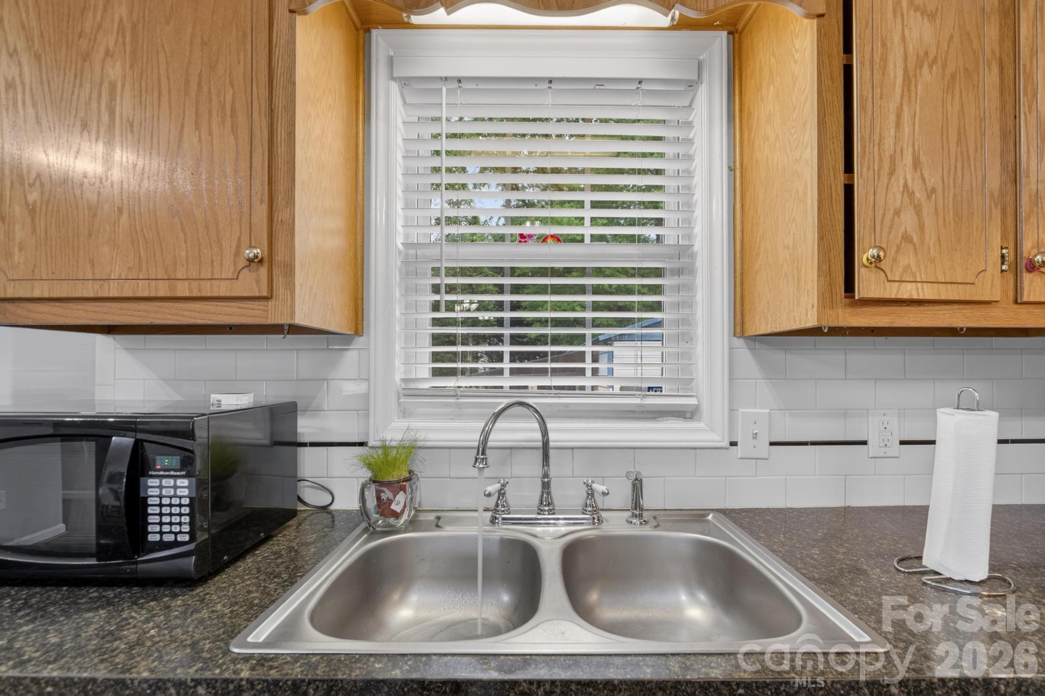 2308 Walt Arney Road Lenoir, NC 28645 - Photo 32 of 37 a kitchen with granite countertop a sink and a window