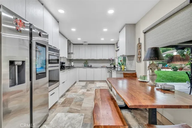 a kitchen with stainless steel appliances a sink and cabinets