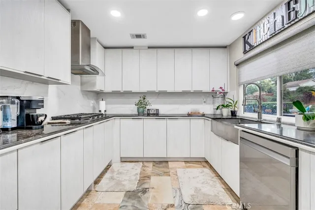 a spacious bedroom with a bed and a chandelier
