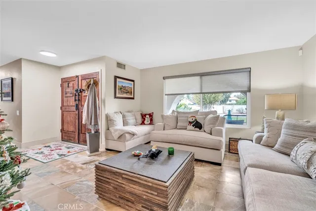 a view of a workspace with furniture and wooden floor