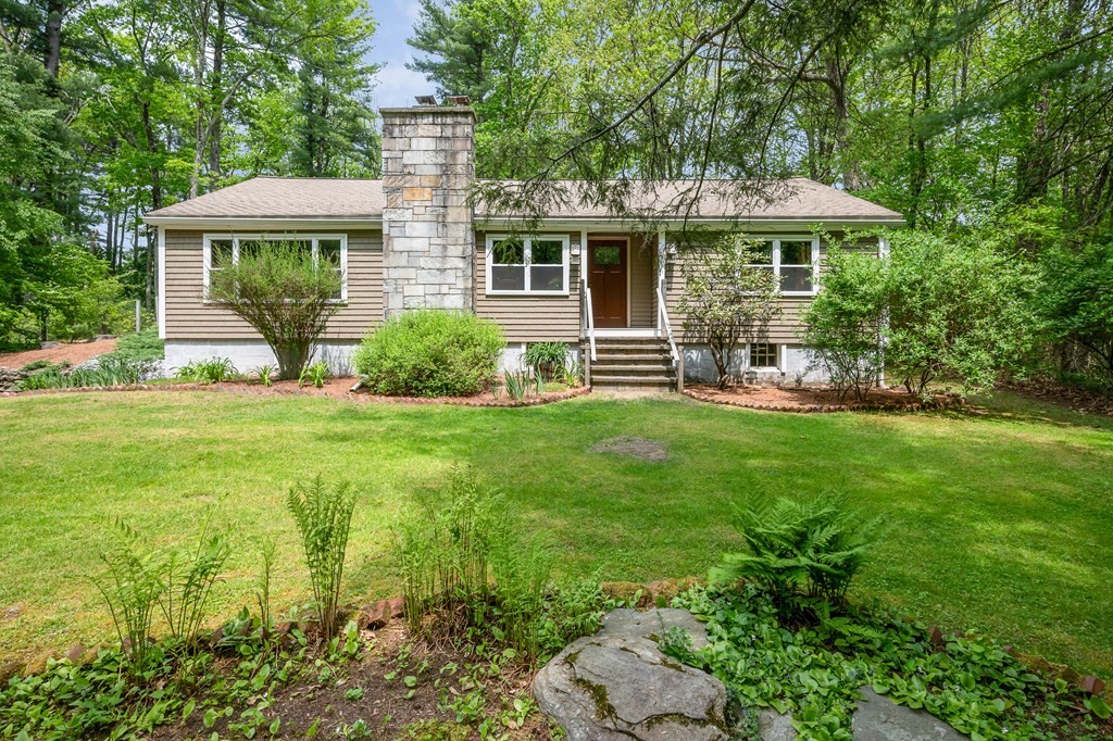 222 Gates Pond Road Berlin, MA 01503 - Photo 1 of 36 a front view of a house with garden and porch