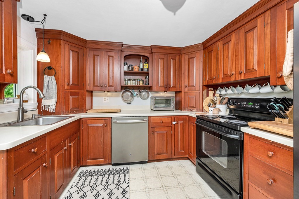 222 Gates Pond Road Berlin, MA 01503 - Photo 11 of 36 a kitchen with stainless steel appliances granite countertop a stove a sink and a microwave