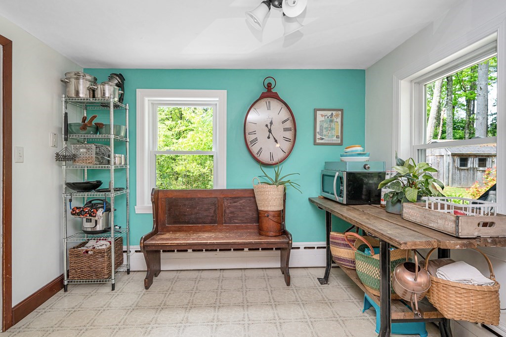 222 Gates Pond Road Berlin, MA 01503 - Photo 12 of 36 a living room with furniture and a clock