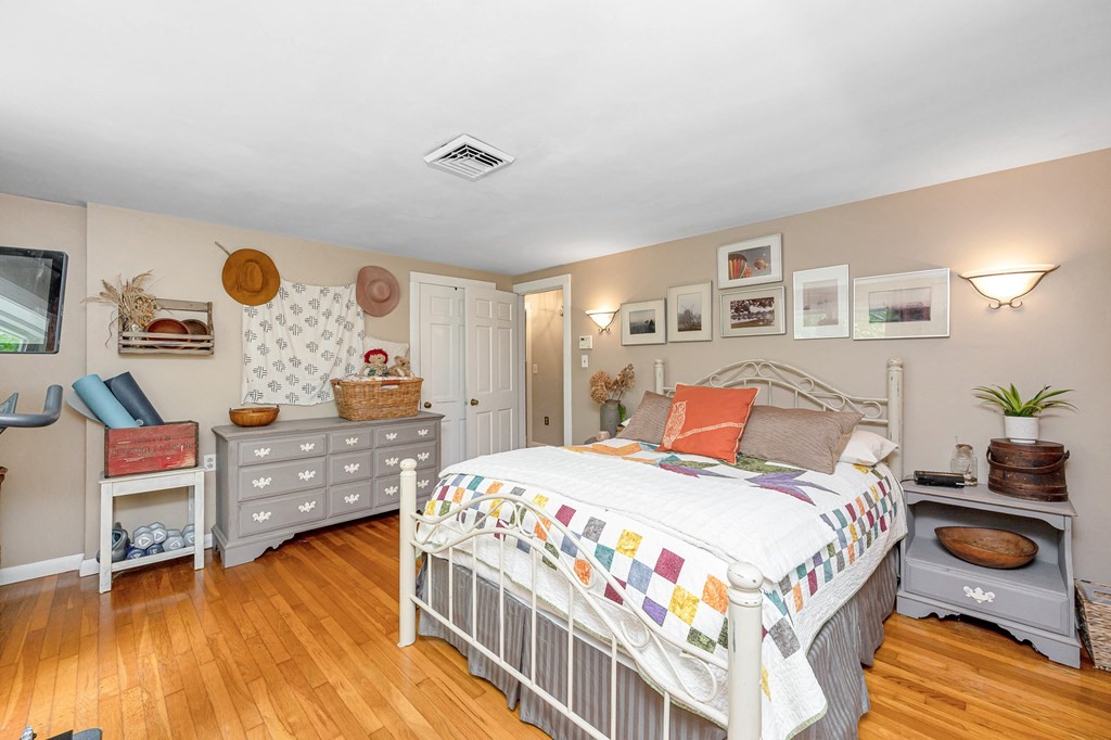 222 Gates Pond Road Berlin, MA 01503 - Photo 14 of 36 a bedroom with a bed and wooden floor