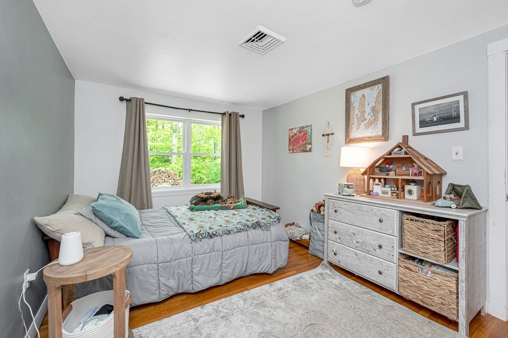 222 Gates Pond Road Berlin, MA 01503 - Photo 21 of 36 a bedroom with a bed and a dresser in it