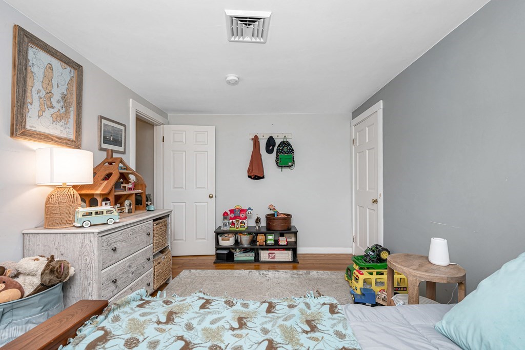 222 Gates Pond Road Berlin, MA 01503 - Photo 22 of 36 a bedroom with furniture and a wooden floor