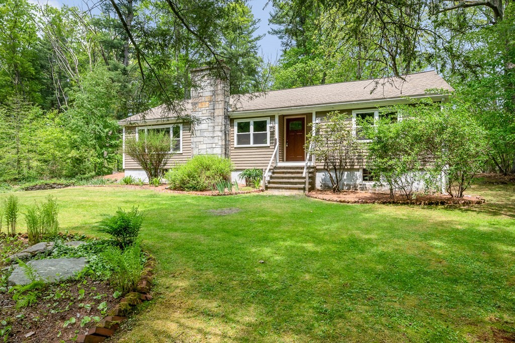 222 Gates Pond Road Berlin, MA 01503 - Photo 30 of 36 a front view of a house with garden
