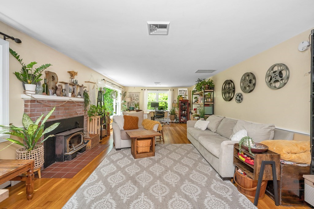 222 Gates Pond Road Berlin, MA 01503 - Photo 3 of 36 a living room with fireplace furniture and a flat screen tv