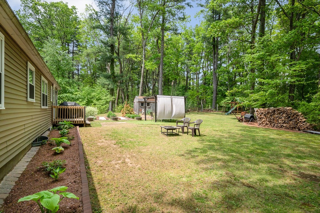 222 Gates Pond Road Berlin, MA 01503 - Photo 31 of 36 a view of a backyard with sitting area