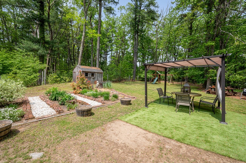 222 Gates Pond Road Berlin, MA 01503 - Photo 33 of 36 an outdoor view of a garden with patio