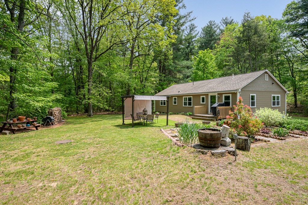 222 Gates Pond Road Berlin, MA 01503 - Photo 36 of 36 a front view of house with yard entertaining space and seating area