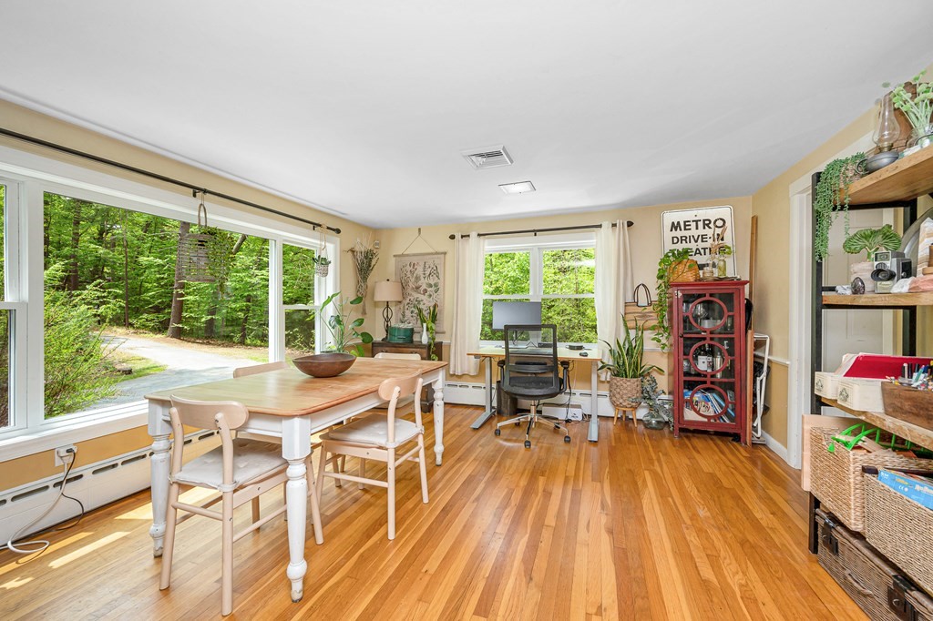 222 Gates Pond Road Berlin, MA 01503 - Photo 7 of 36 a dining room with a wooden floor and a window