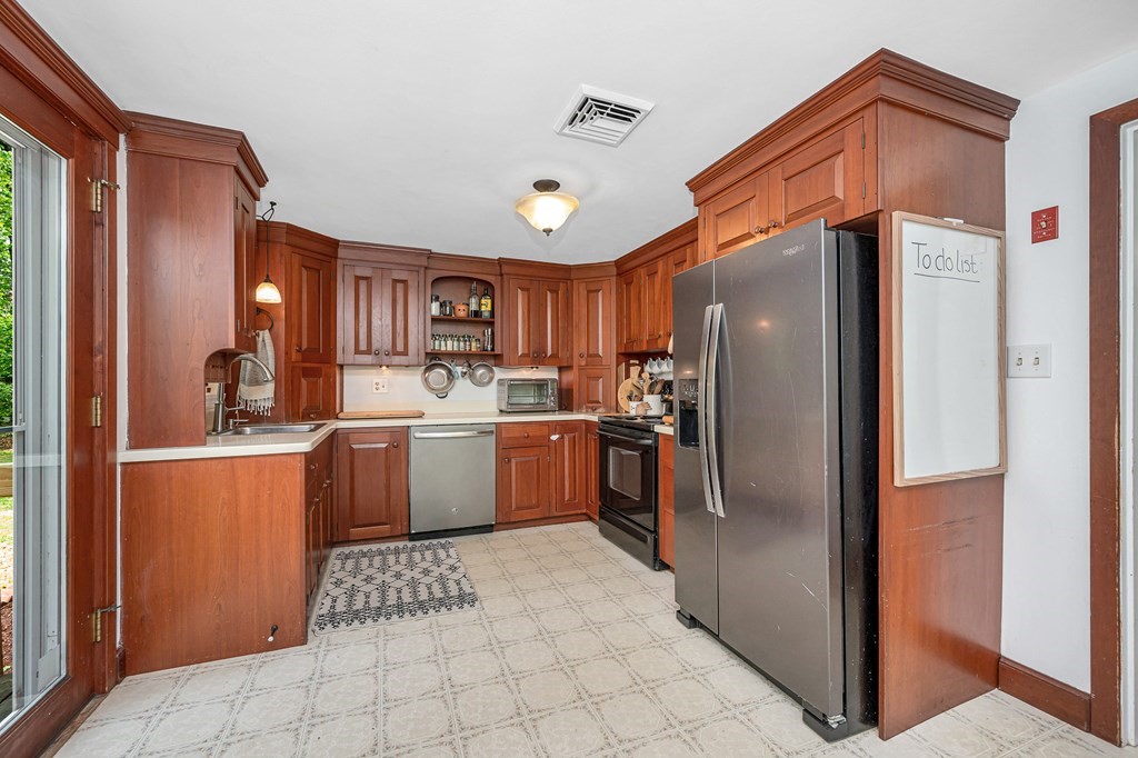 222 Gates Pond Road Berlin, MA 01503 - Photo 10 of 36 a kitchen with stainless steel appliances granite countertop a refrigerator and a sink
