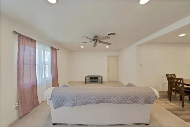 a bedroom with a large bed and a chandelier