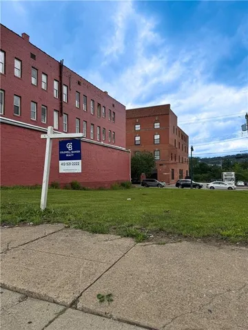 a brick building with a yard
