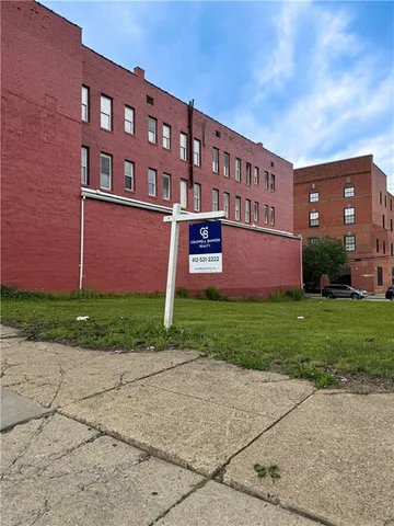a view of a brick building next to a yard