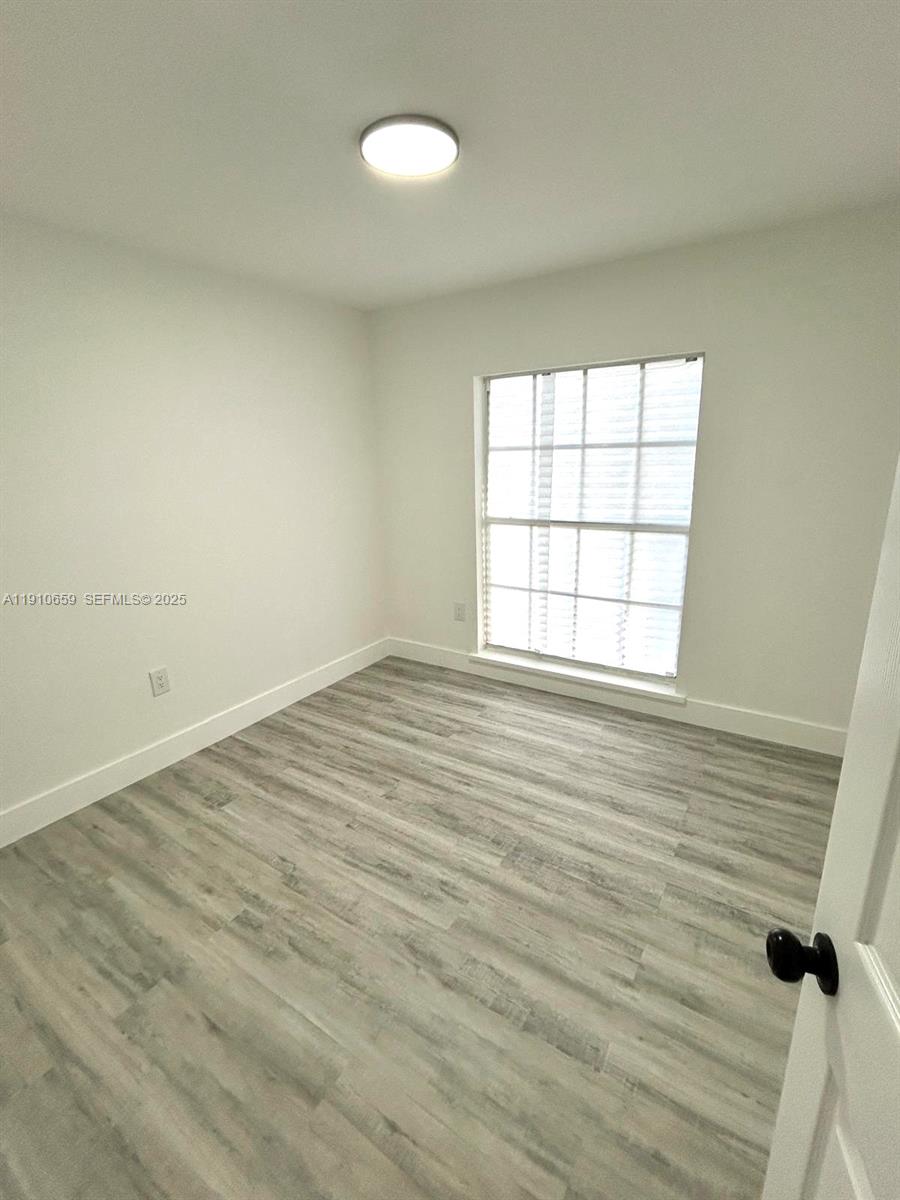 14211 Southwest 286th Street Homestead, FL 33033 - Photo 21 of 38 wooden floor in an empty room with a window